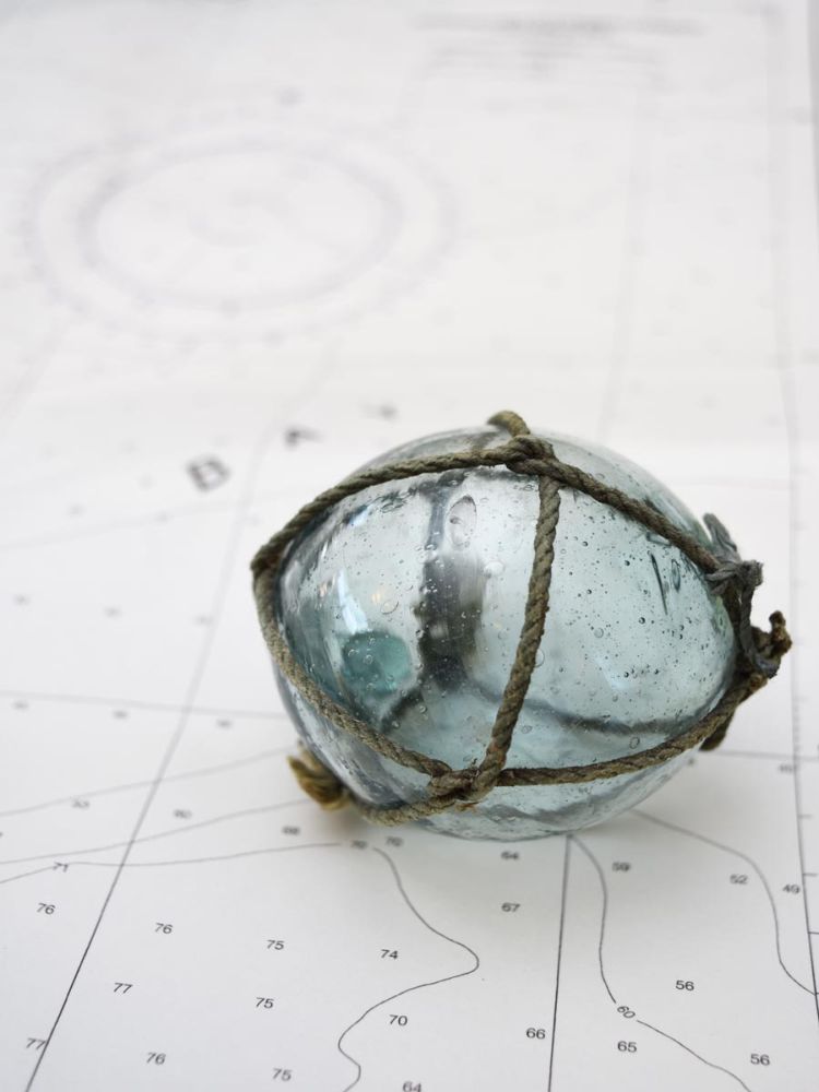 Glass fishing float on chart